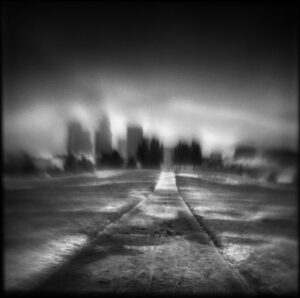 A black and white photo of an empty road.