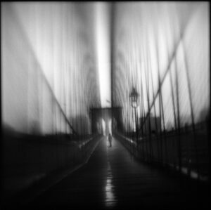 A blurry image of a person walking on the bridge.