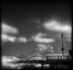 A black and white photo of the sky with clouds.
