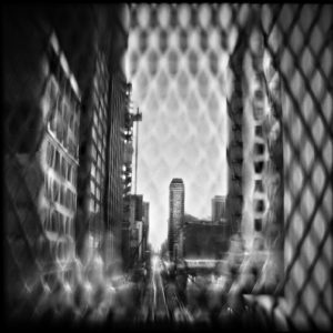 A view of buildings through the fence.