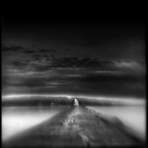 A black and white photo of an empty road