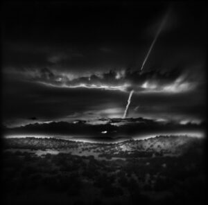A black and white photo of the sky with clouds