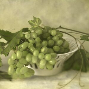 A bowl of green grapes on the table.