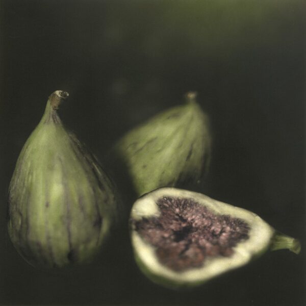 A painting of three figs with one cut in half.