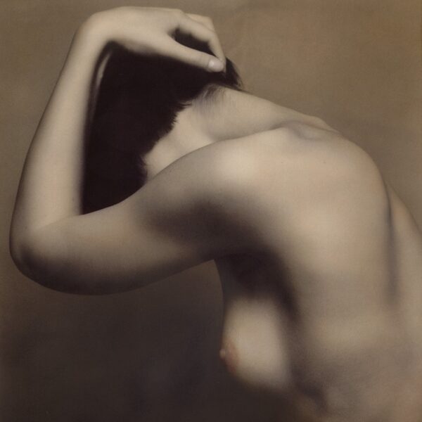 A woman with her arms up and head down.