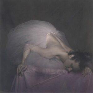 A woman in white dress leaning on the ground.