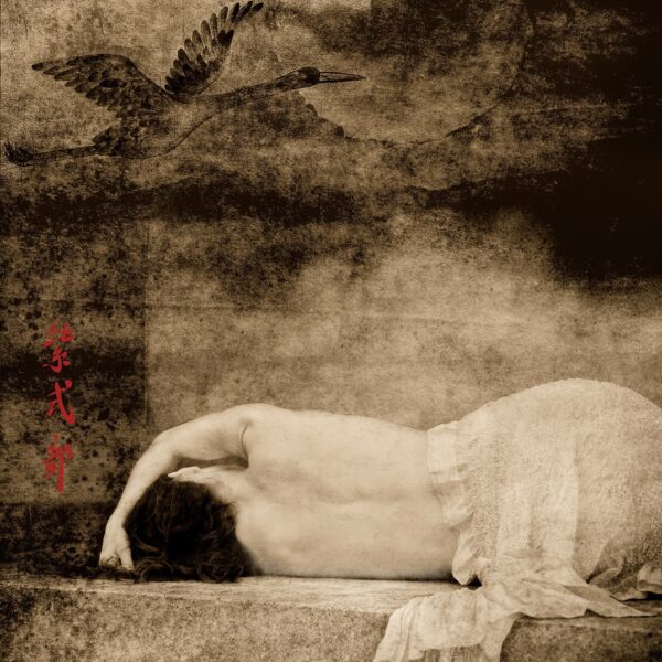 A woman laying on the ground with her head down.