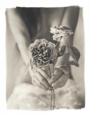 A woman holding flowers in her hands.