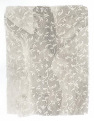 A white lace curtain with floral designs.