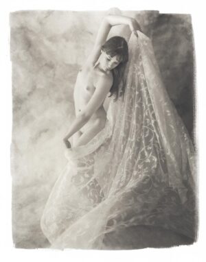 A woman in a white dress posing for the camera.
