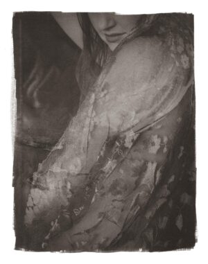 A black and white photo of a woman in a dress