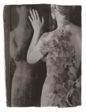 A woman in a dress standing next to a mannequin.