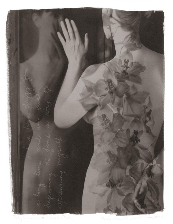 A woman in a dress standing next to a mannequin.
