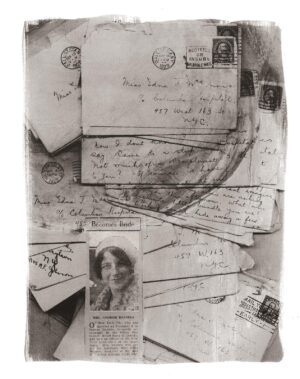 A pile of old letters and envelopes with a woman 's face on top.