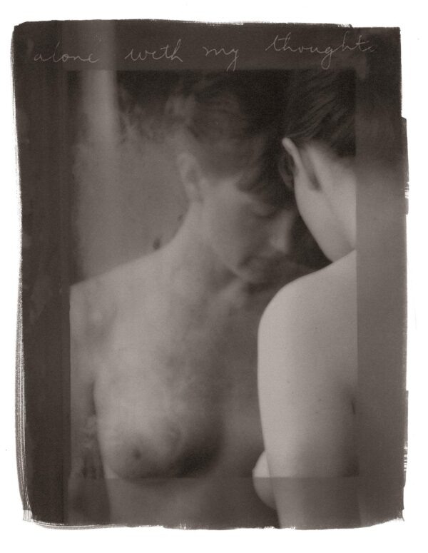 A man and woman are in the mirror.