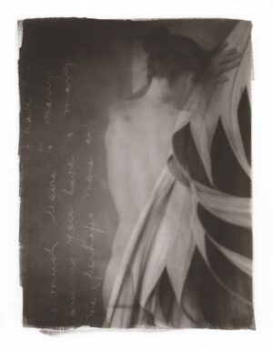 A black and white photo of a person with a flower
