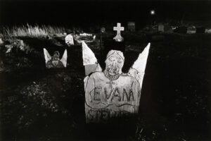 A cemetery with several tombstones and crosses.