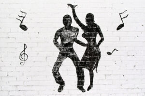 A black and white image of two people dancing.
