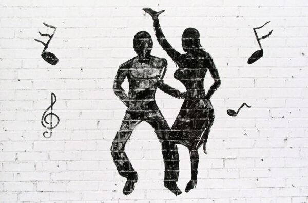 A black and white image of two people dancing.