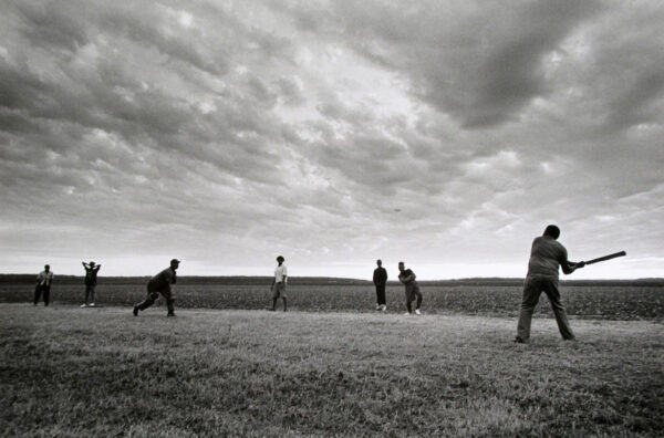 A group of people playing baseball in the field.