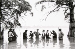 A group of people standing in the water.