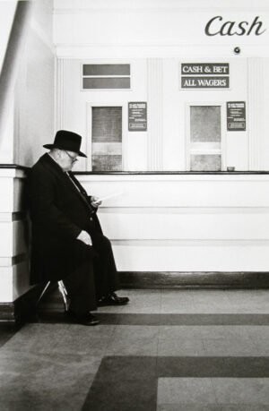 A man sitting on the steps of a building.