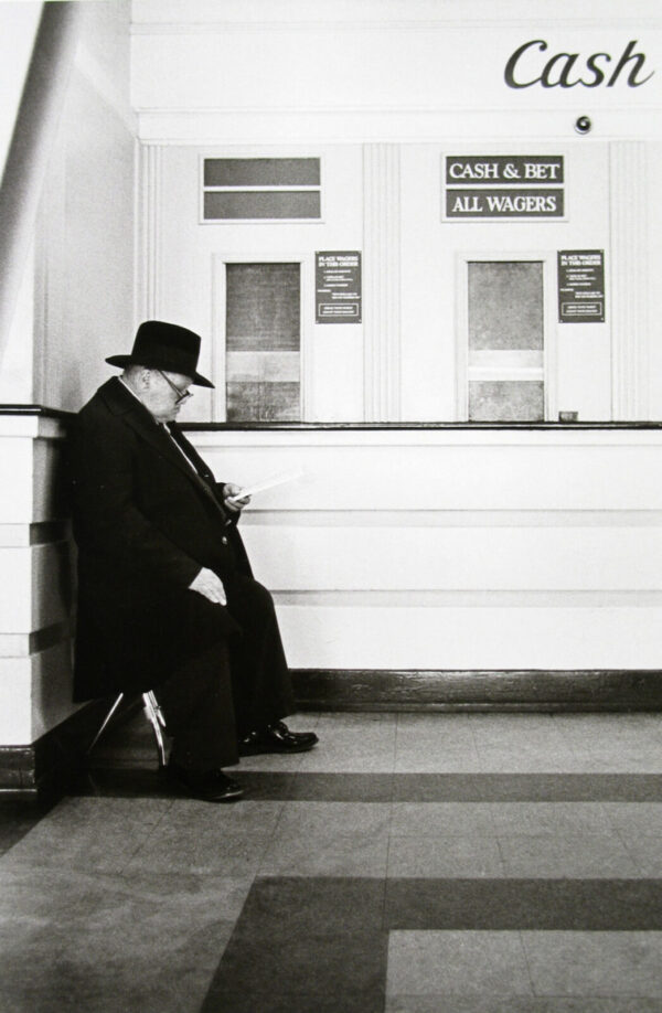 A man sitting on the steps of a building.