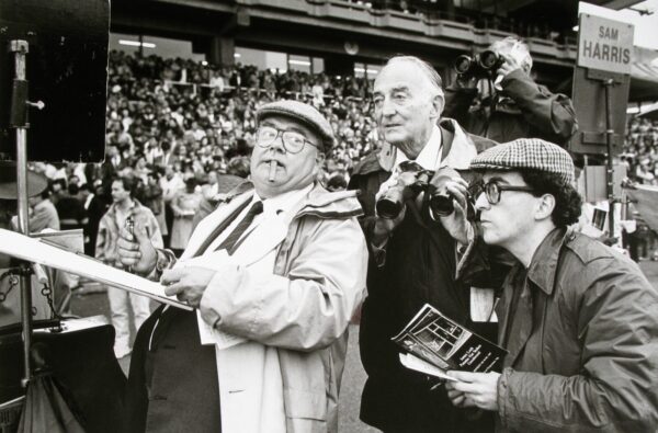 A group of men standing in front of an audience.