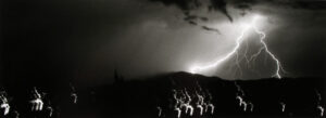 A group of people standing on top of a hill.