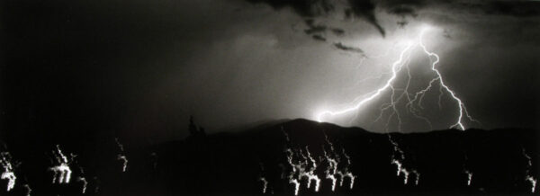 A group of people standing on top of a hill.
