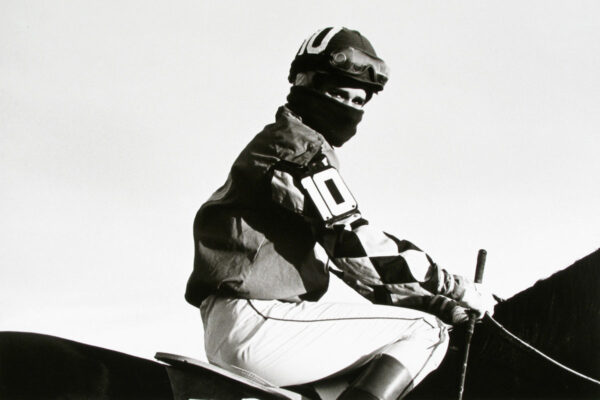 A man riding on the back of a motorcycle.