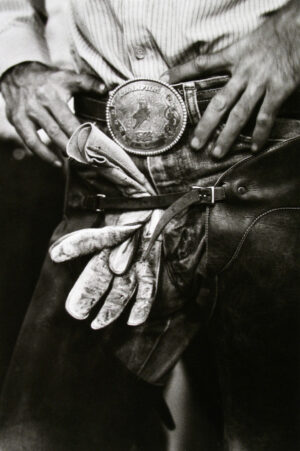 A person holding something in their hand and wearing gloves.