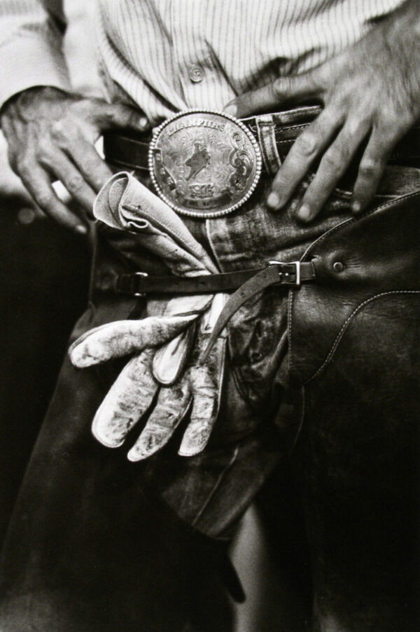 A person holding something in their hand and wearing gloves.
