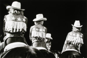 A group of people wearing cowboy hats and jackets.