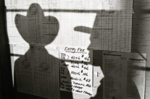 A person is standing in front of a window with papers on it.