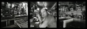 A man sitting at the bar of a restaurant.