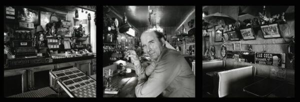 A man sitting at the bar of a restaurant.