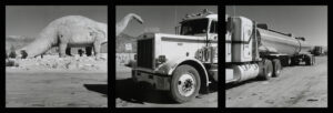 A large truck with a hand on the side of it.