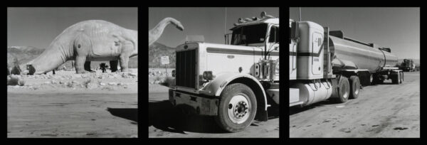 A large truck with a hand on the side of it.