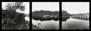 A black and white photo of a lake with boats.