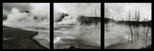A black and white photo of steam rising from the ground.