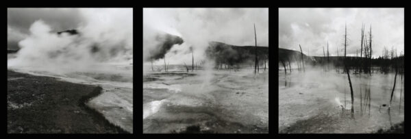 A black and white photo of steam rising from the ground.