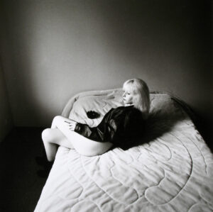 A child laying on the bed in a room.