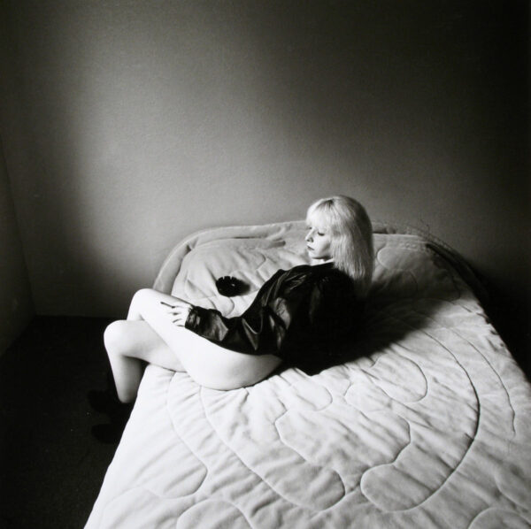 A child laying on the bed in a room.