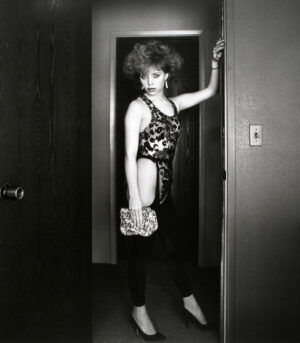 A woman standing in front of a door.