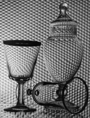 A black and white photo of two glasses.