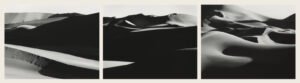 A black and white photo of some sand dunes