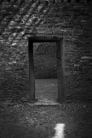 A black and white photo of an open door.