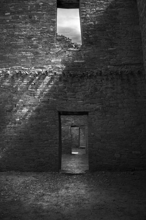 A black and white photo of an open door.