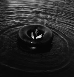 A black and white photo of a floating object in water.
